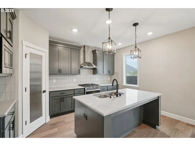 a kitchen with a sink a counter space and appliances