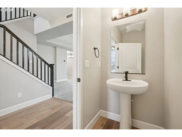 a bathroom with a sink a mirror and shower