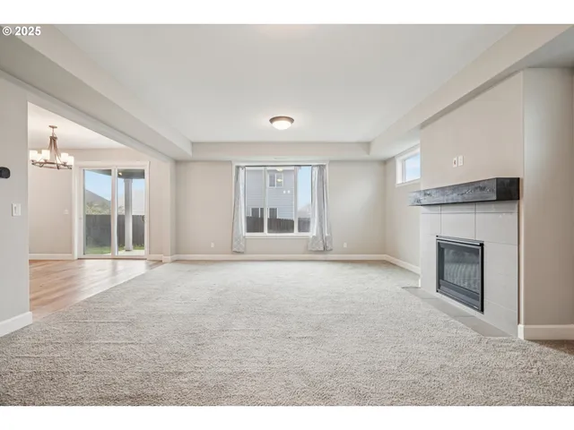 a view of empty room with a fireplace