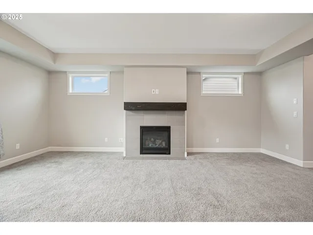 a view of an empty room with a fireplace