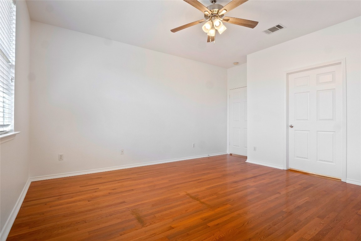 601 Red Hawk Drive Leander, TX 78641 - Photo 19 of 40 Primary bedroom featuring wood-type flooring and a ceiling fan