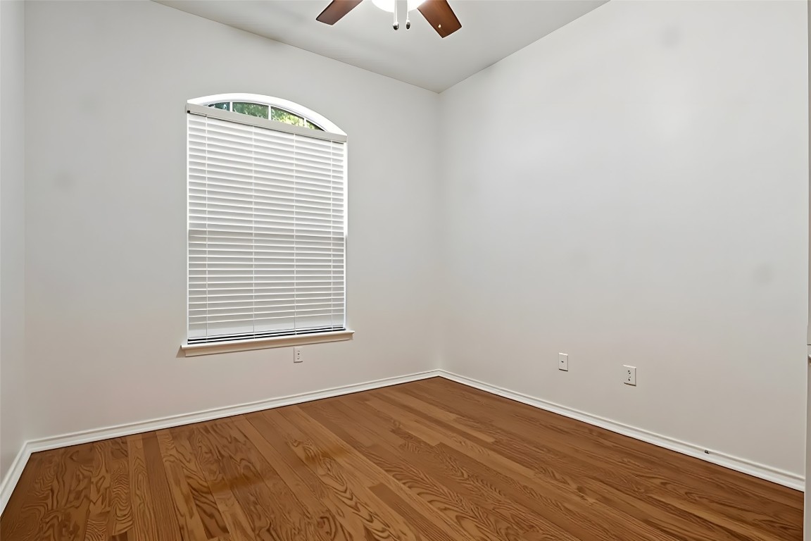 601 Red Hawk Drive Leander, TX 78641 - Photo 26 of 40 Bedroom #2 with light wood finished floors and ceiling fan