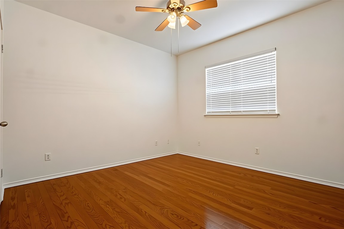 601 Red Hawk Drive Leander, TX 78641 - Photo 30 of 40 Bedroom #4 with light wood finished floors and ceiling fan