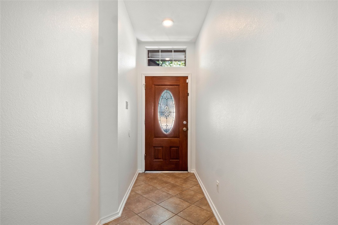 601 Red Hawk Drive Leander, TX 78641 - Photo 3 of 40 Doorway to outside with baseboards and tile patterned floors