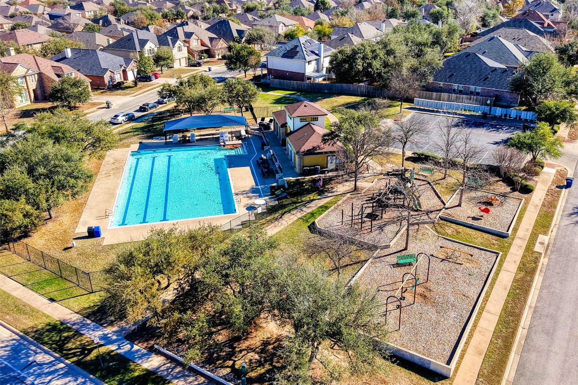 601 Red Hawk Drive Leander, TX 78641 - Photo 33 of 40 Aerial view of residential area featuring a community pool and a playground