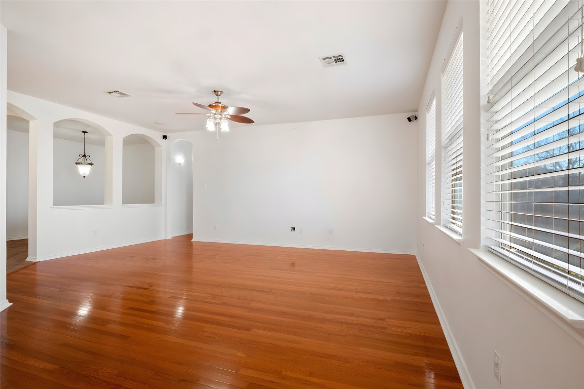 601 Red Hawk Drive Leander, TX 78641 - Photo 5 of 40 Living area with arched walkways, wood finished floors, and ceiling fan
