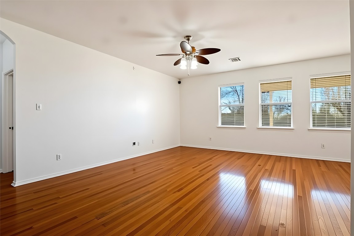 601 Red Hawk Drive Leander, TX 78641 - Photo 7 of 40 Living area with wood finished floors, and ceiling fan