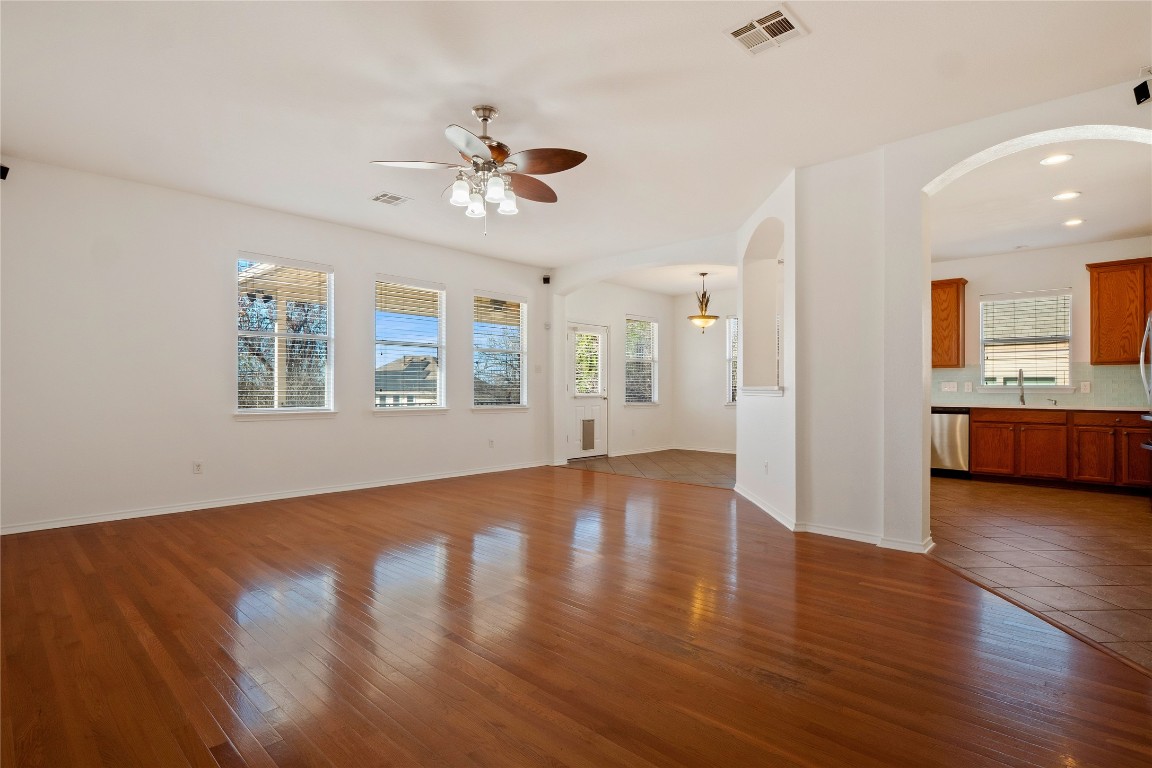 601 Red Hawk Drive Leander, TX 78641 - Photo 8 of 40 Living area with arched walkways, wood finished floors, and ceiling fan
