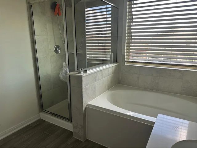 a bathroom with a bathtub and a shower