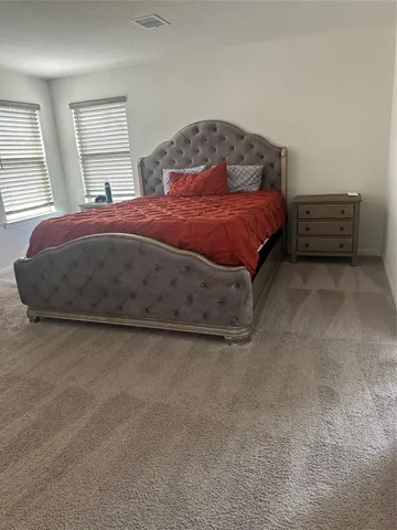a bedroom with a bed and a dresser