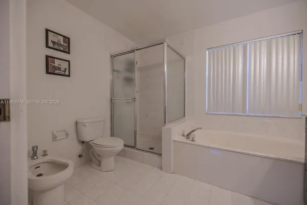 a bathroom with a toilet a sink and bathtub