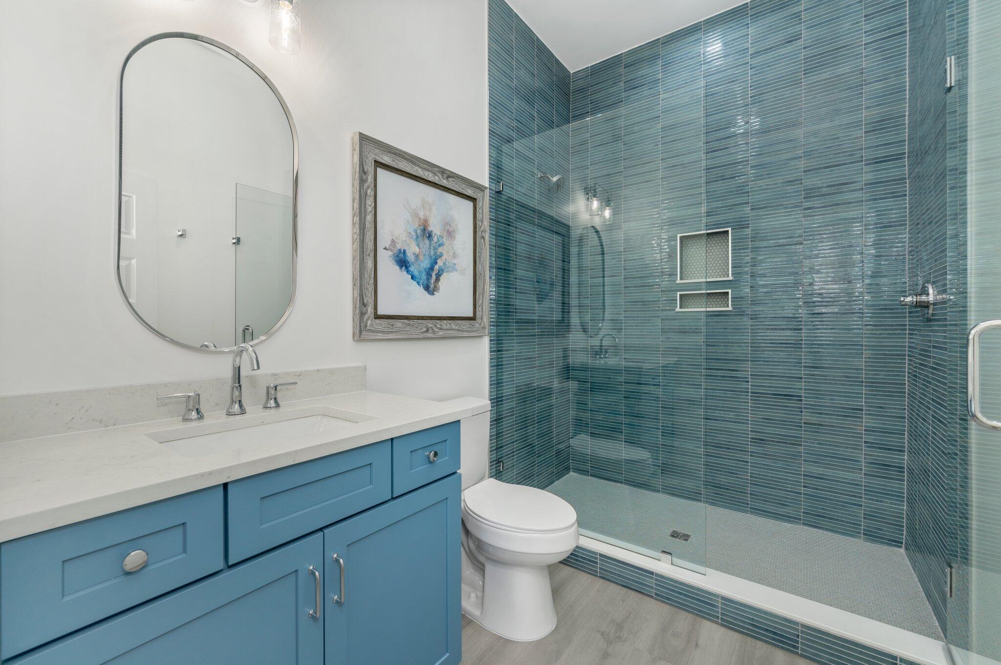 4553 Luke Avenue Destin, FL 32541 - Photo 30 of 70 a bathroom with a toilet sink and mirror