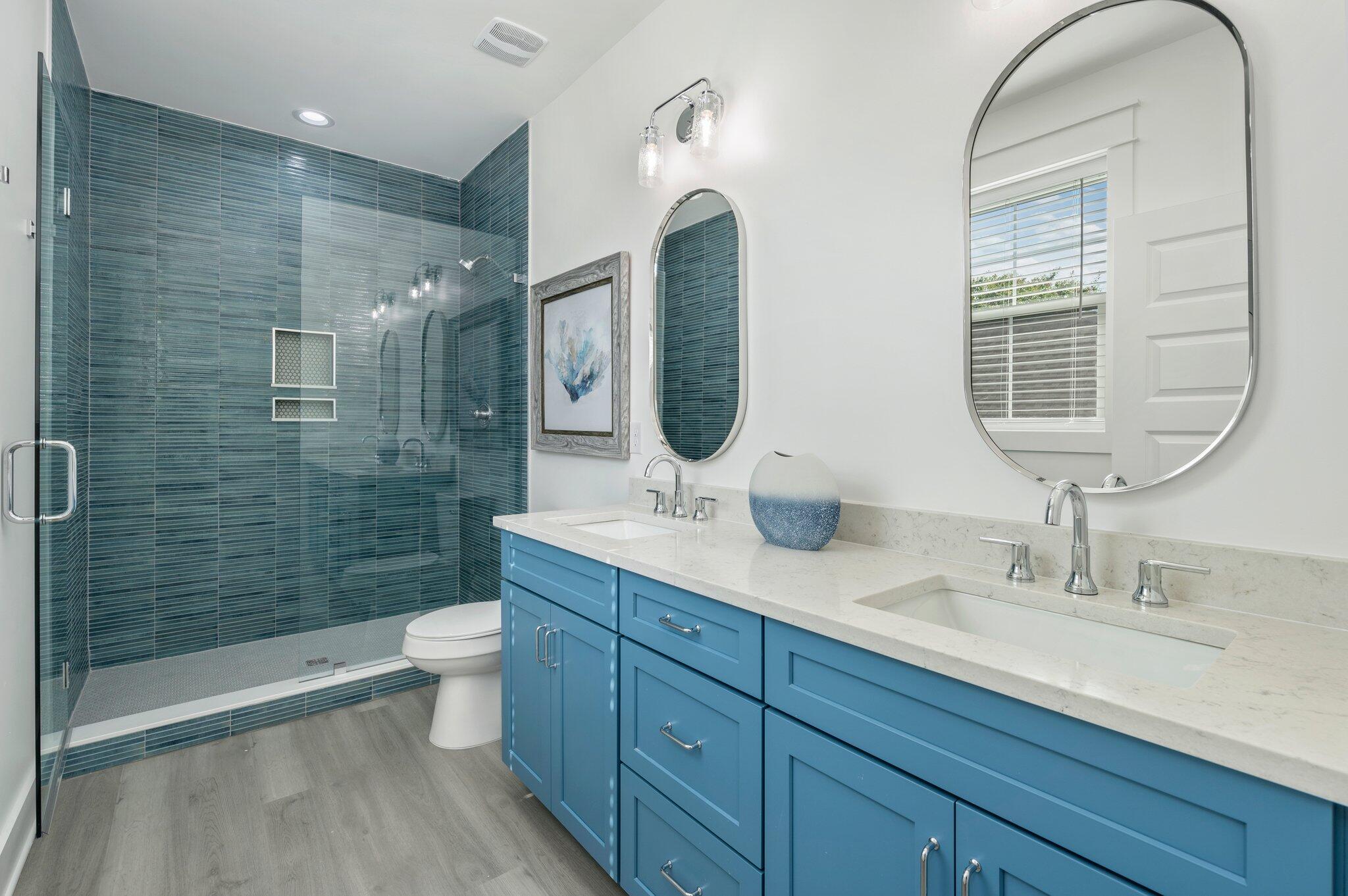4553 Luke Avenue Destin, FL 32541 - Photo 40 of 70 a bathroom with a double vanity sink toilet and shower