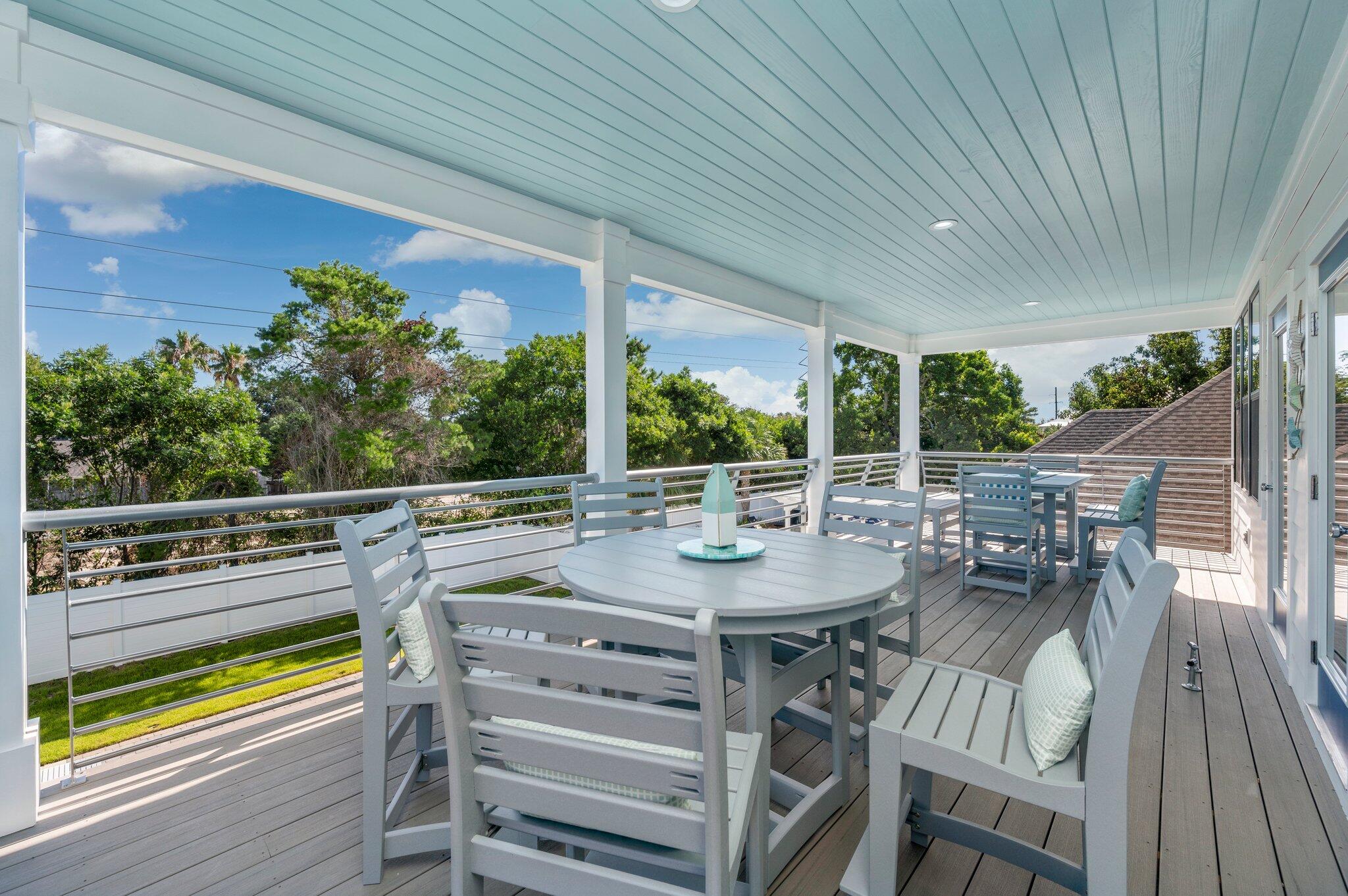 4553 Luke Avenue Destin, FL 32541 - Photo 52 of 70 a view of a patio with table and chairs and wooden floor