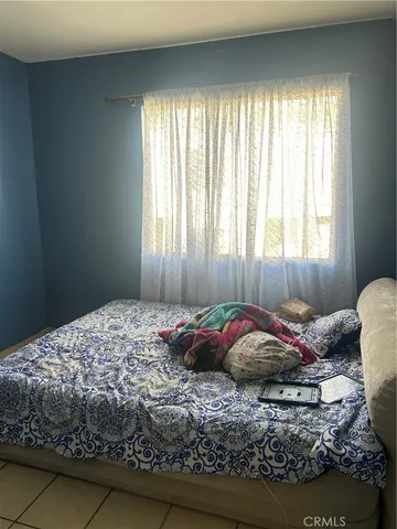 a bedroom with a bed and a window