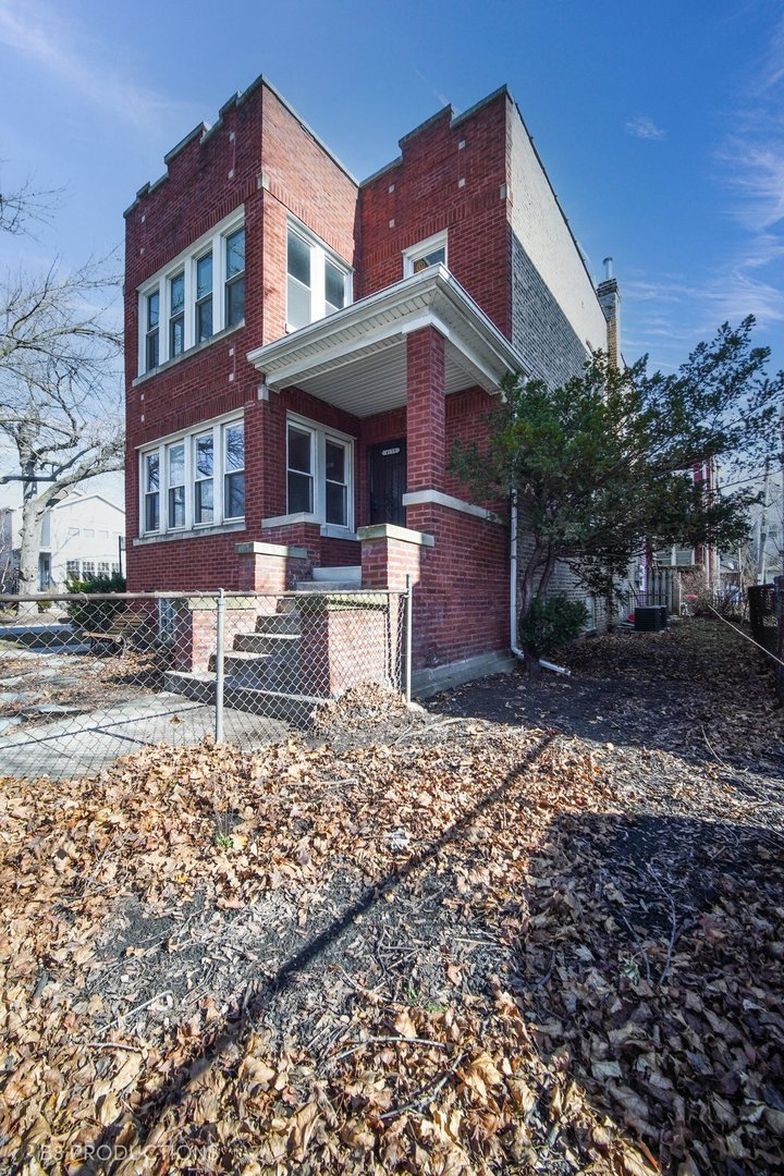 4159 North Maplewood Avenue Chicago, IL 60618 - Photo 21 of 31 a front view of a house with a yard
