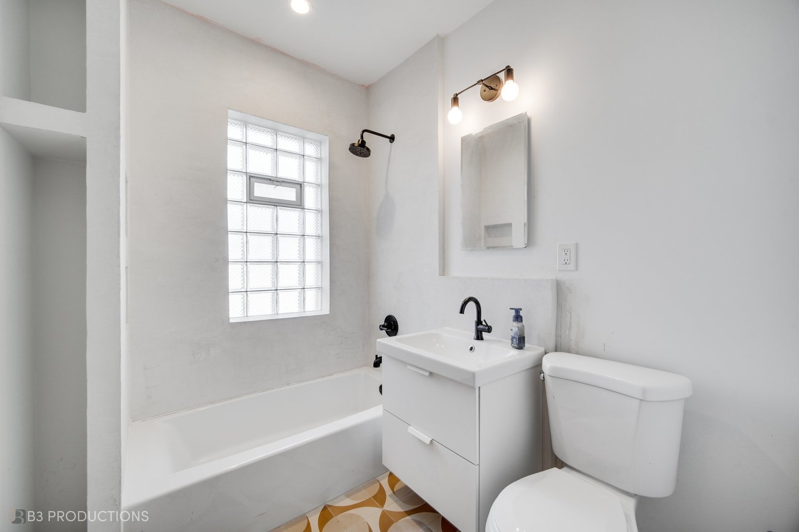 4159 North Maplewood Avenue Chicago, IL 60618 - Photo 8 of 31 a white toilet sitting next to a bathroom sink