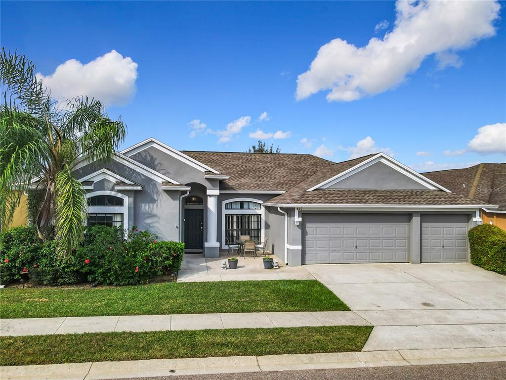 429 Coventry Road Davenport, FL 33897 - Photo 1 of 1 a front view of a house with garden