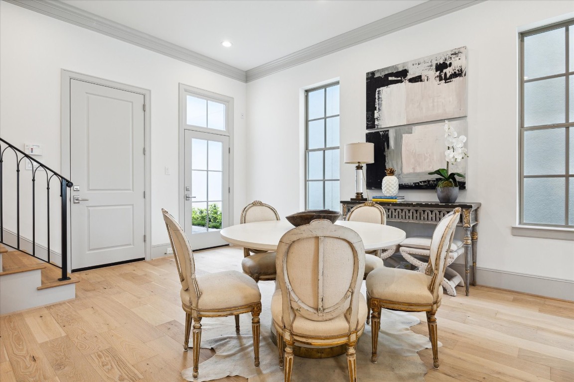 207 Sutton Row Place Houston, TX 77024 - Photo 11 of 30 a view of a dining room with furniture window and wooden floor