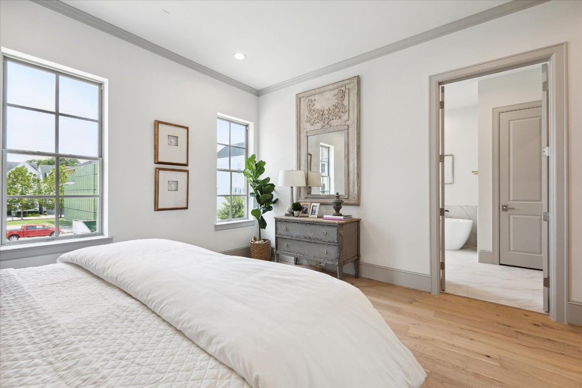 207 Sutton Row Place Houston, TX 77024 - Photo 14 of 30 a bedroom with a large bed and a window