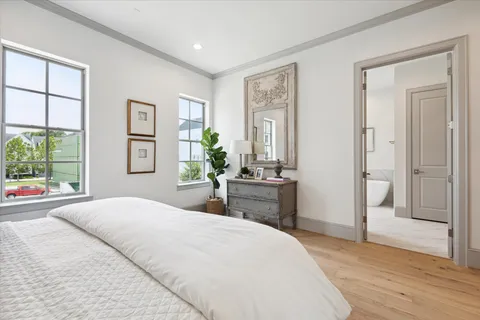 a bathroom with a double vanity sink large mirror and a bathtub