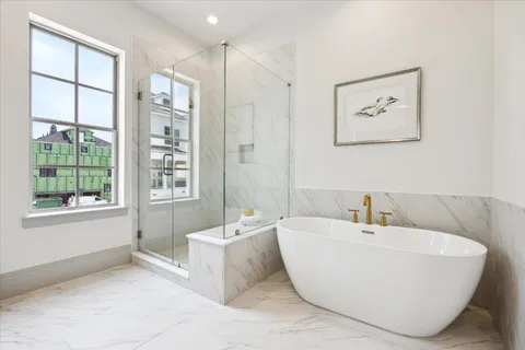 a bathroom with a granite countertop toilet sink and mirror