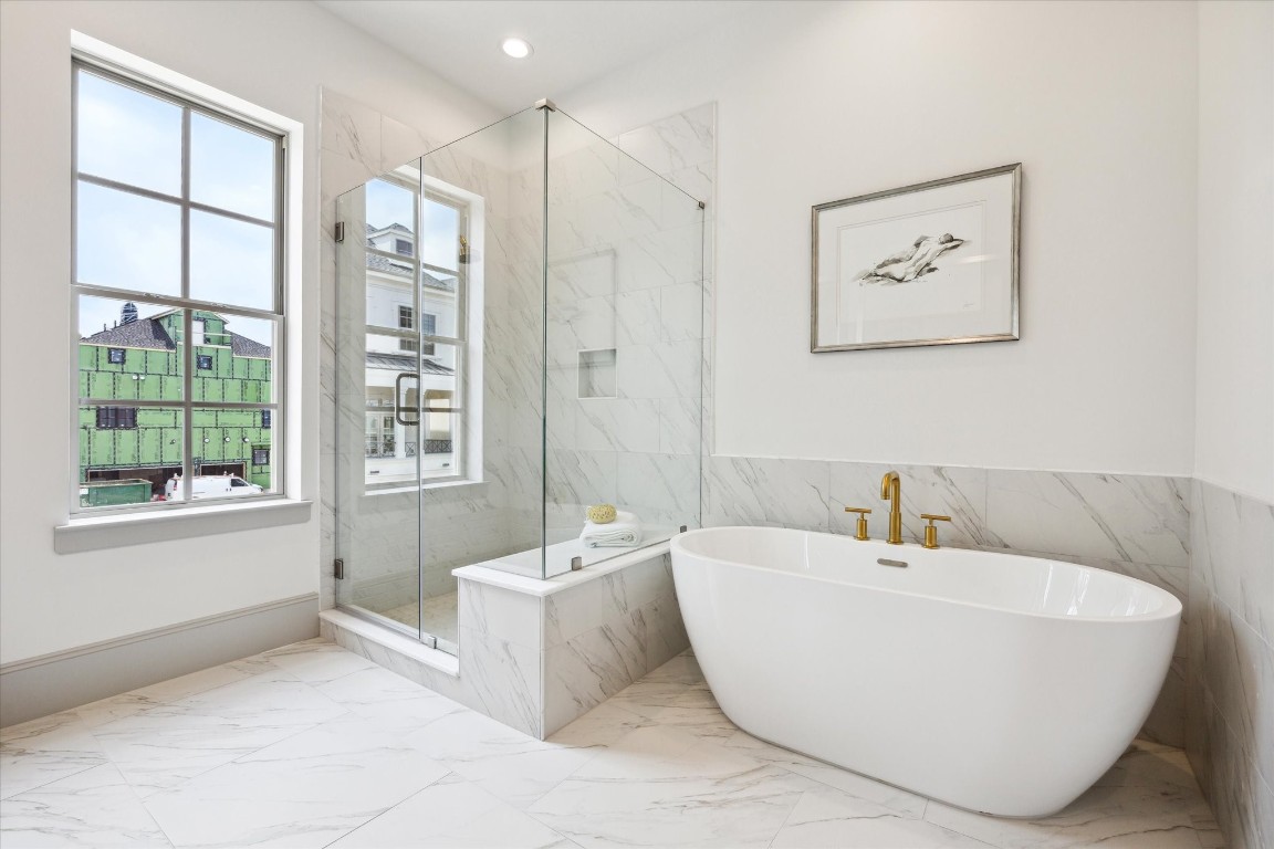 207 Sutton Row Place Houston, TX 77024 - Photo 16 of 30 a bathroom with a bathtub and next to a window
