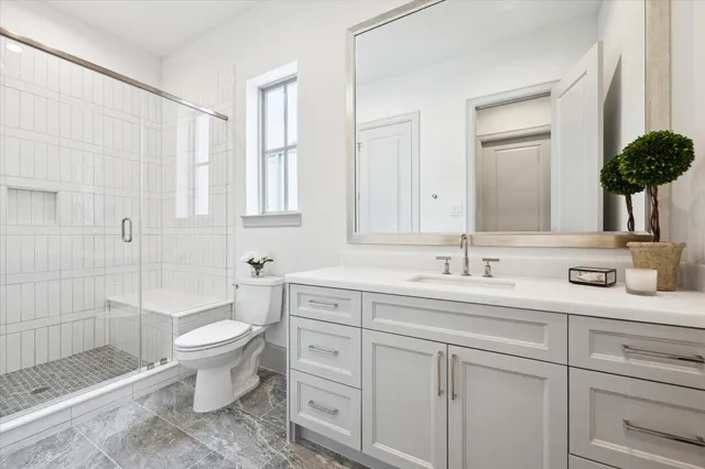 a room with white cabinets and sink