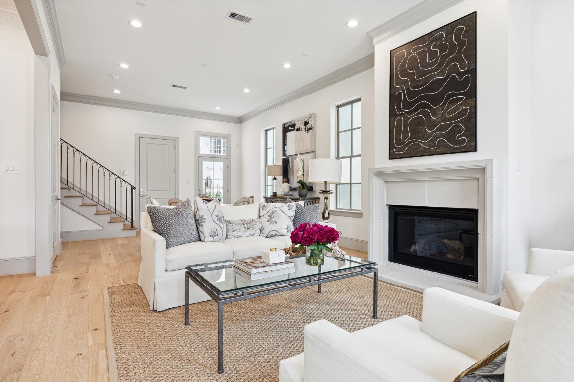 207 Sutton Row Place Houston, TX 77024 - Photo 2 of 30 a living room with furniture potted plant and a fireplace