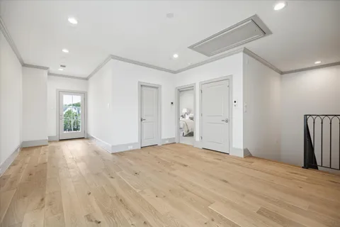 a spacious bedroom with a bed a table and chair