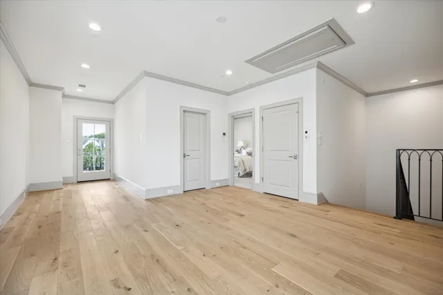 a spacious bedroom with a bed a table and chair