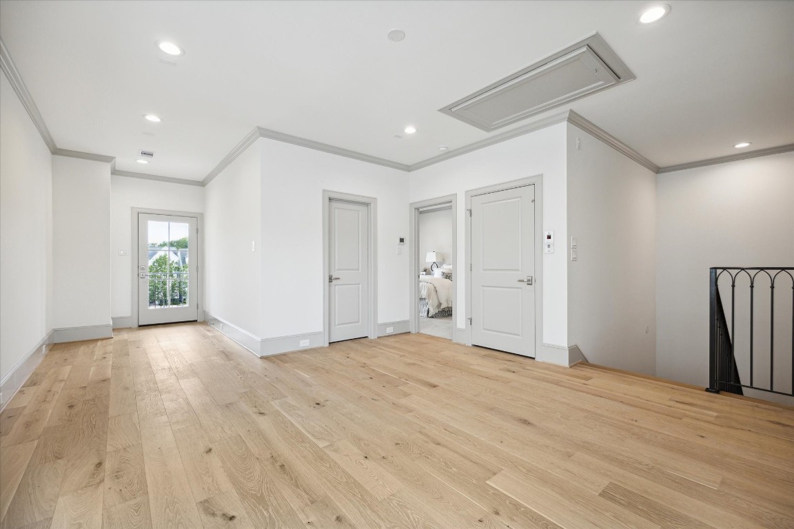 207 Sutton Row Place Houston, TX 77024 - Photo 21 of 30 a view of empty room with wooden floor and fan
