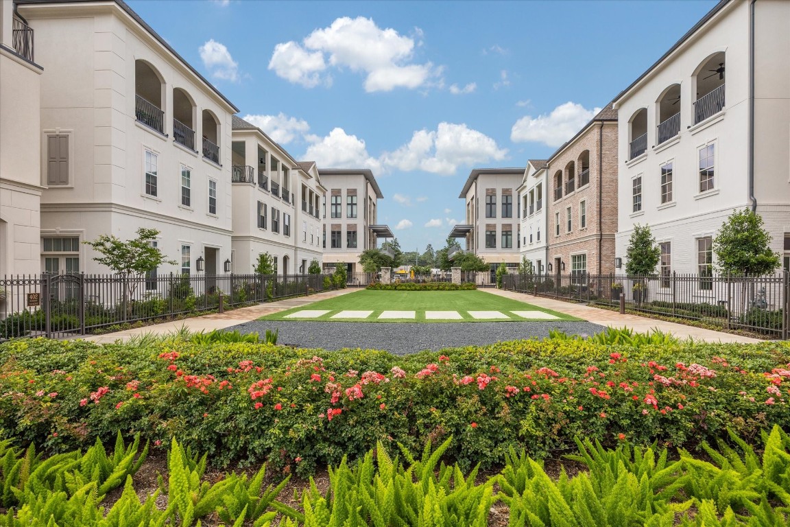 207 Sutton Row Place Houston, TX 77024 - Photo 26 of 30 a view of an apartment with a swimming pool and a yard