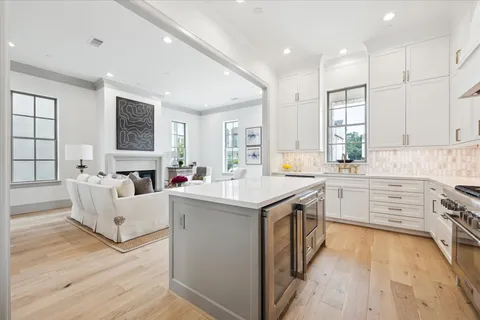 a kitchen with kitchen island granite countertop a stove and a sink