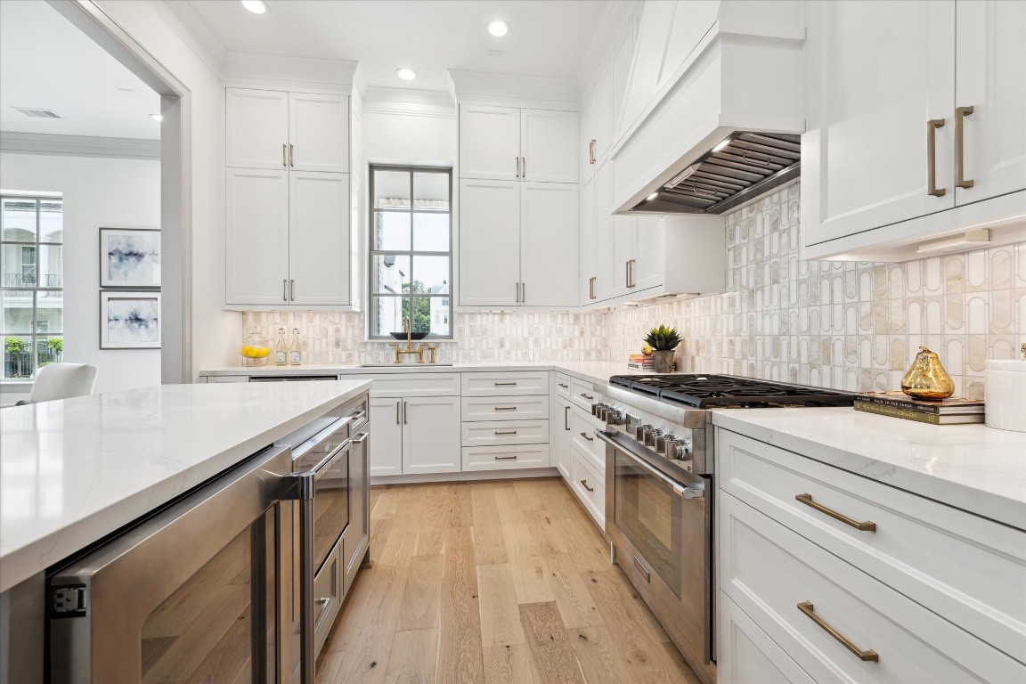 207 Sutton Row Place Houston, TX 77024 - Photo 6 of 30 a kitchen with a sink a stove and cabinets