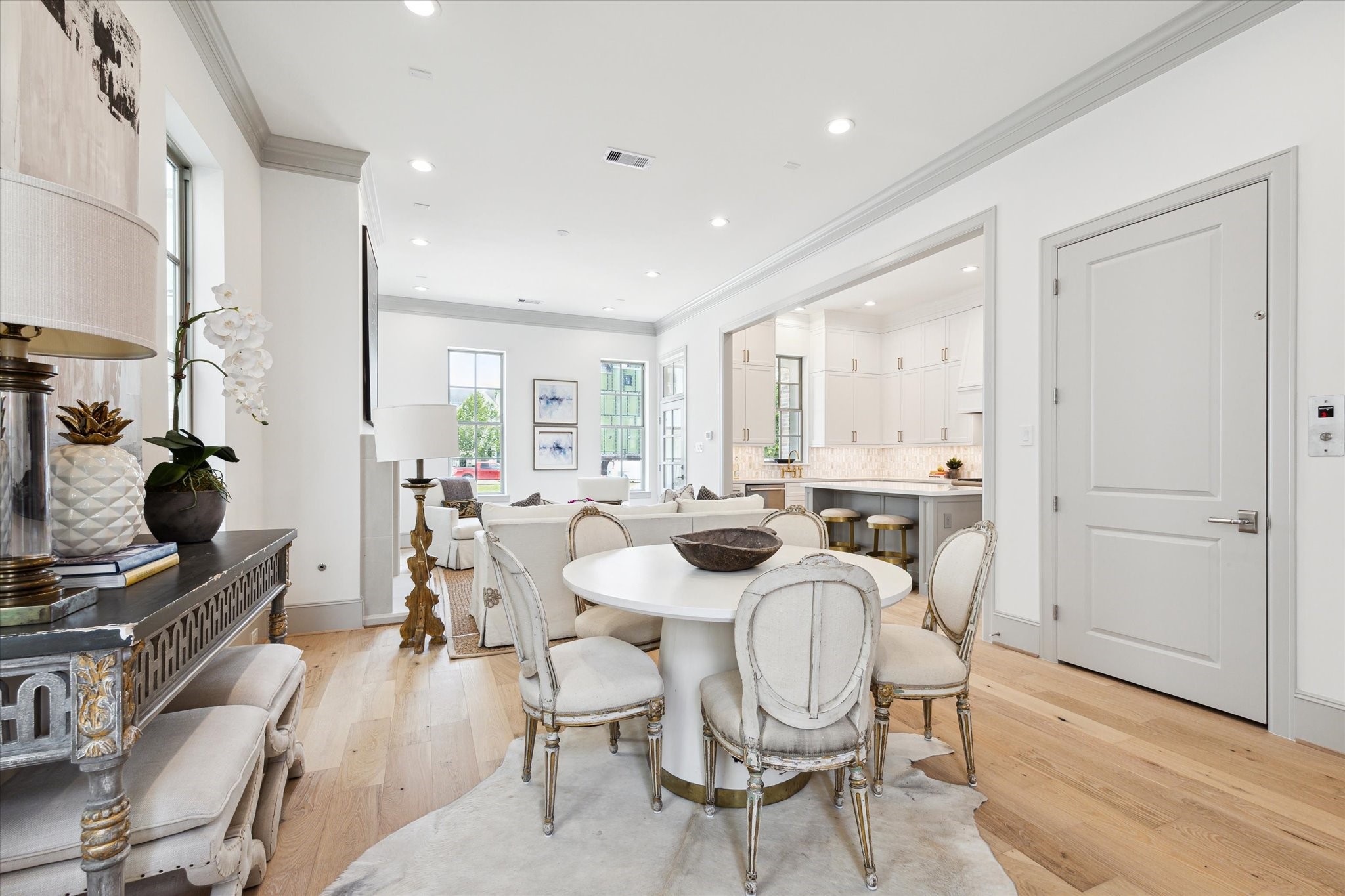 207 Sutton Row Place Houston, TX 77024 - Photo 7 of 30 a view of a dining room with furniture a rug and wooden floor
