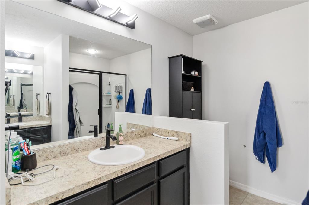 559 Siesta Key Avenue Tavares, FL 32778 - Photo 13 of 24 a bathroom with a double vanity sink and a mirror