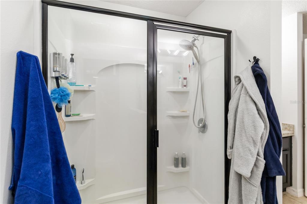 559 Siesta Key Avenue Tavares, FL 32778 - Photo 14 of 24 a bathroom with a shower and a mirror