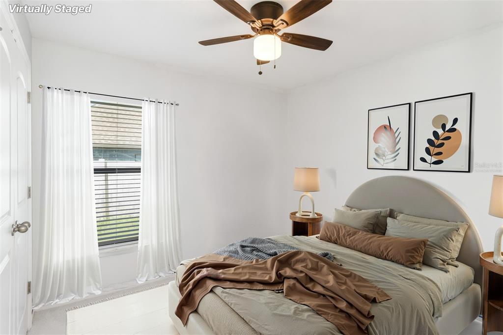 559 Siesta Key Avenue Tavares, FL 32778 - Photo 15 of 24 a bedroom with a bed and a painting on the wall