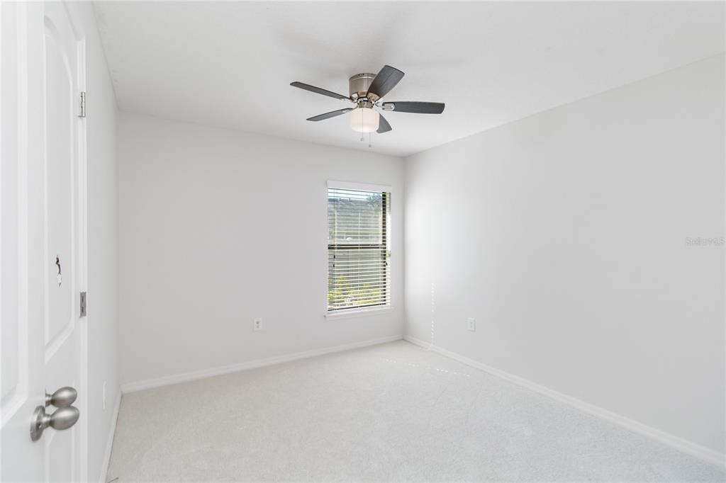 559 Siesta Key Avenue Tavares, FL 32778 - Photo 17 of 24 an empty room with windows and fan