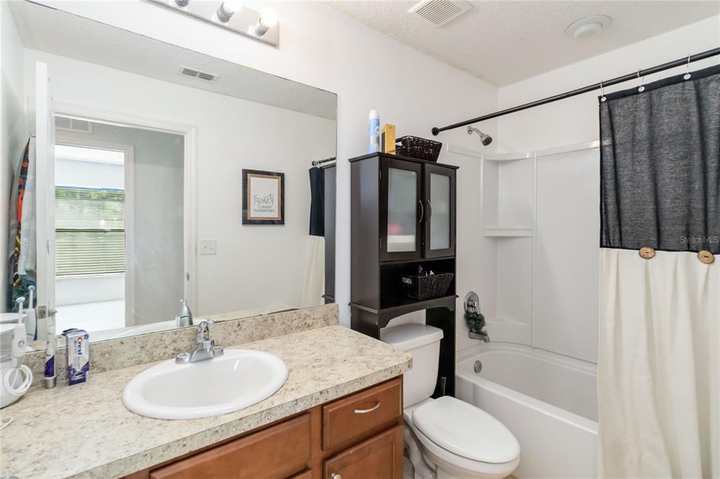 559 Siesta Key Avenue Tavares, FL 32778 - Photo 19 of 24 a bathroom with a sink toilet tub and shower