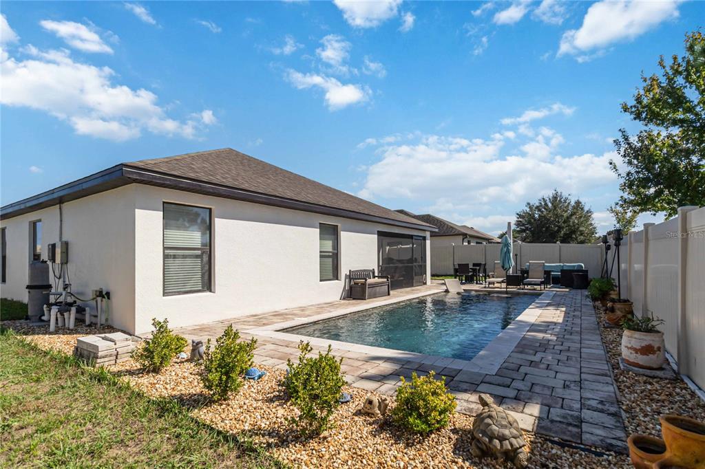 559 Siesta Key Avenue Tavares, FL 32778 - Photo 22 of 24 a backyard of a house with table and chairs