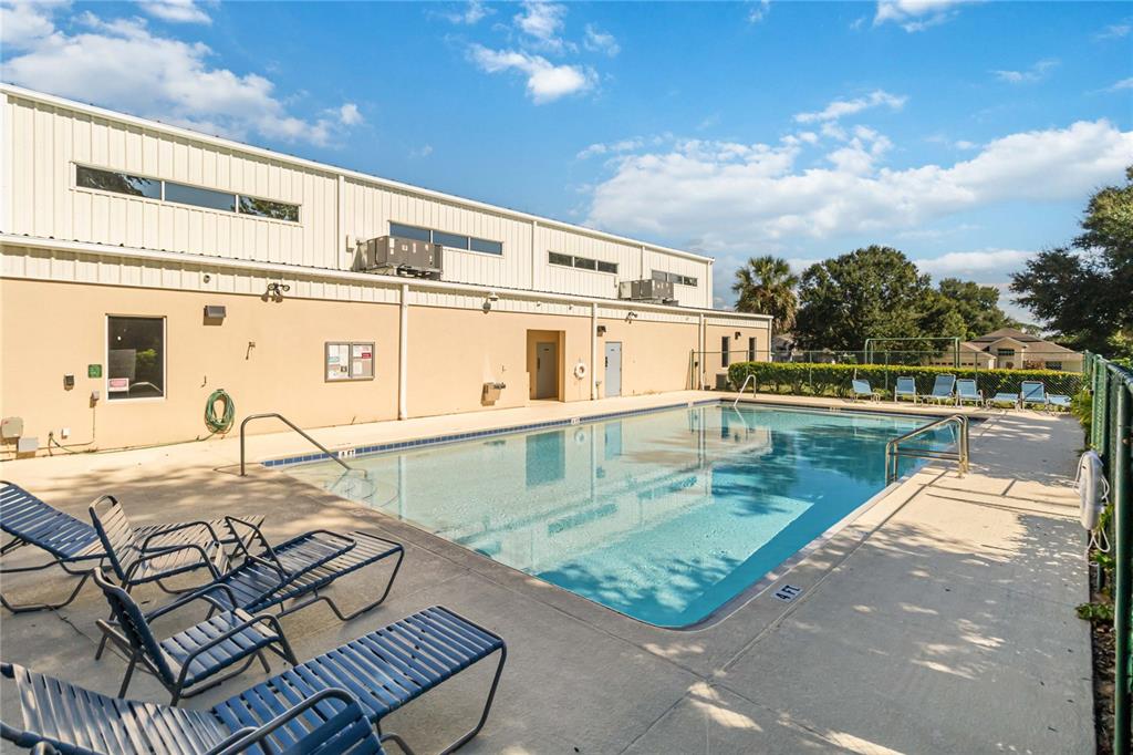 559 Siesta Key Avenue Tavares, FL 32778 - Photo 24 of 24 a view of a swimming pool with a lounge chairs
