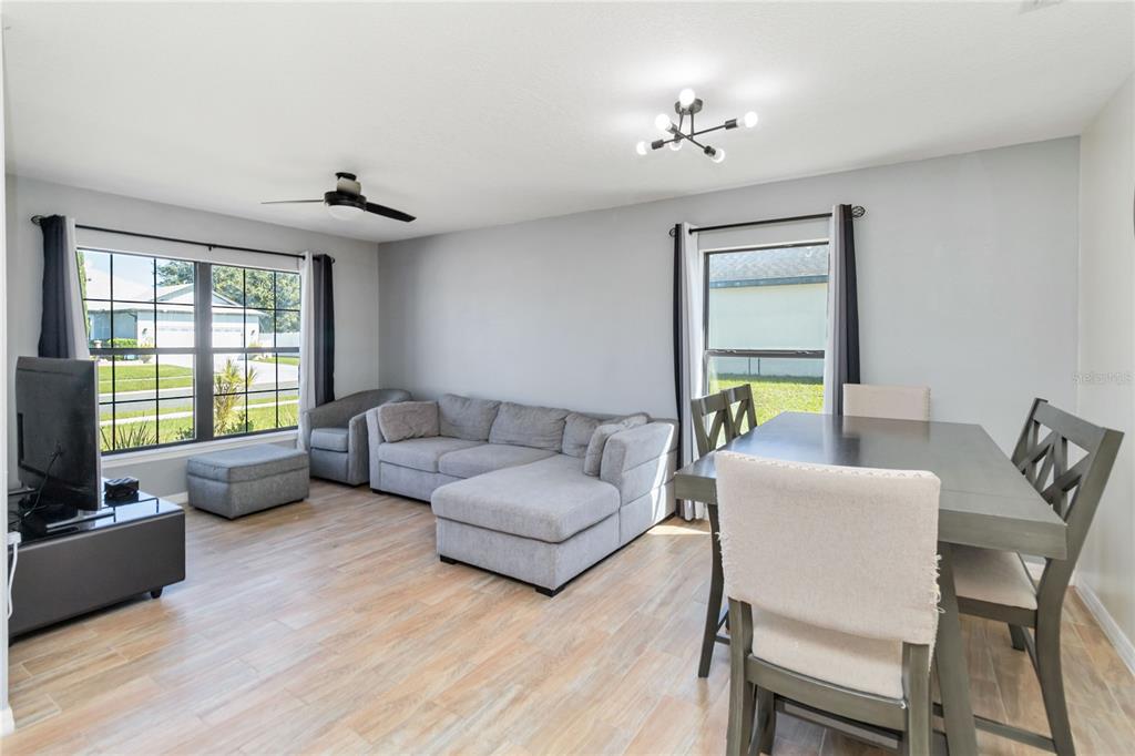 559 Siesta Key Avenue Tavares, FL 32778 - Photo 3 of 24 a living room with furniture and a flat screen tv