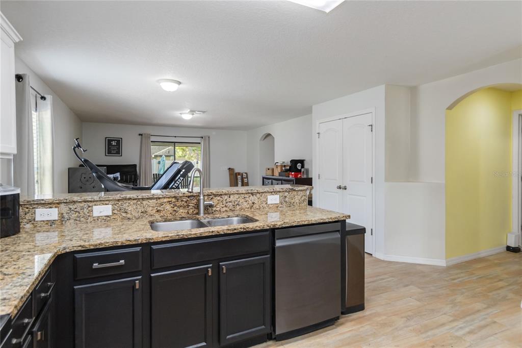 559 Siesta Key Avenue Tavares, FL 32778 - Photo 7 of 24 a kitchen with granite countertop a sink and cabinets