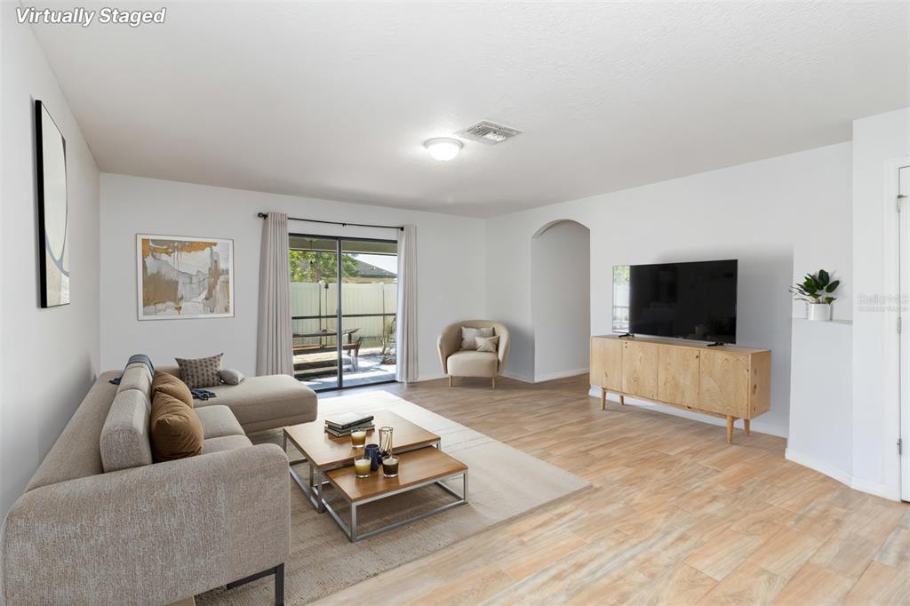 559 Siesta Key Avenue Tavares, FL 32778 - Photo 8 of 24 a living room with furniture and a flat screen tv