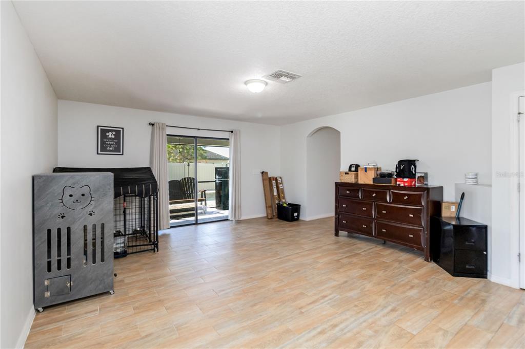 559 Siesta Key Avenue Tavares, FL 32778 - Photo 9 of 24 a room with furniture and a flat screen tv