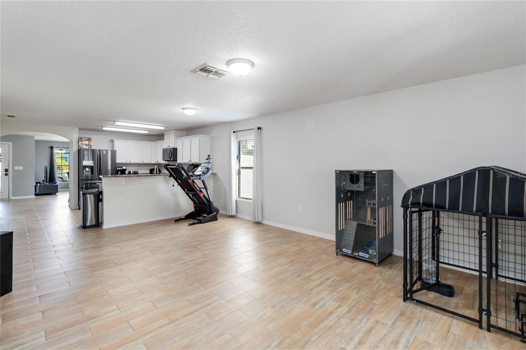 559 Siesta Key Avenue Tavares, FL 32778 - Photo 10 of 24 a view of a room with gym equipment and a large window