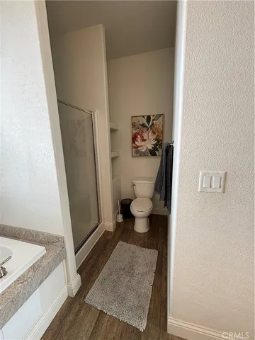 a white toilet sitting next to a sink