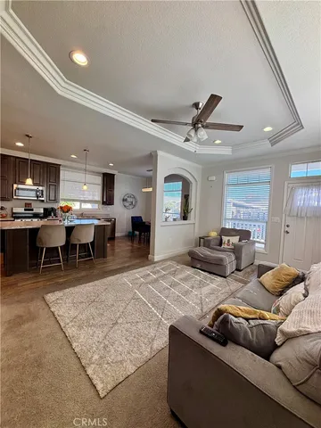 a living room with furniture and kitchen view